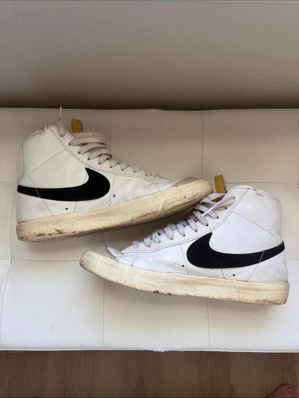 Nike White High-Top Sneakers with Black Swoosh and Yellow Heel Tab